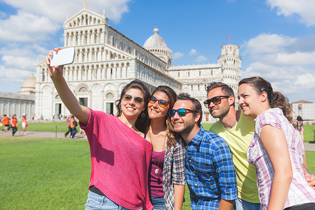 Group of tourists taking a selfie in Pisa.