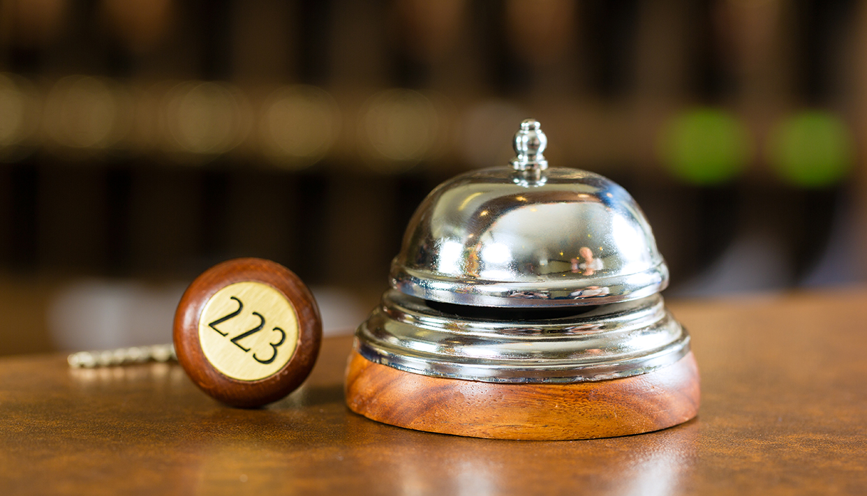 Reception – Hotel bell and key lying on the desk
