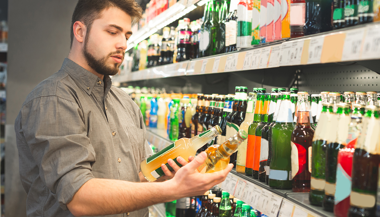 Man’s portrait is in the alcohol department of a supermarket wit