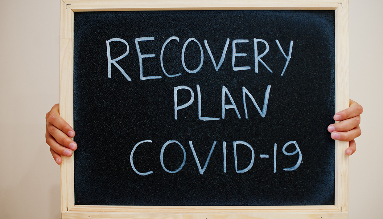 Recovery plan Covid-19. Coronavirus concept. Boy hold inscriptio
